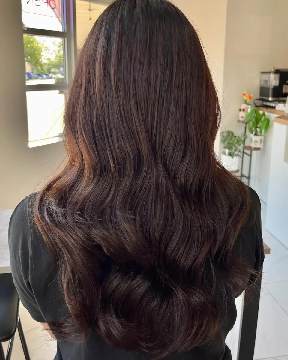 Long, voluminous wave perm in chocolate brown